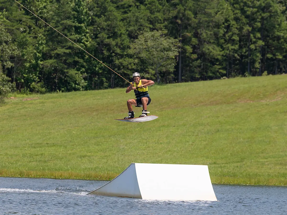 A camper wakeboarding on the Brookhill Ranch lake