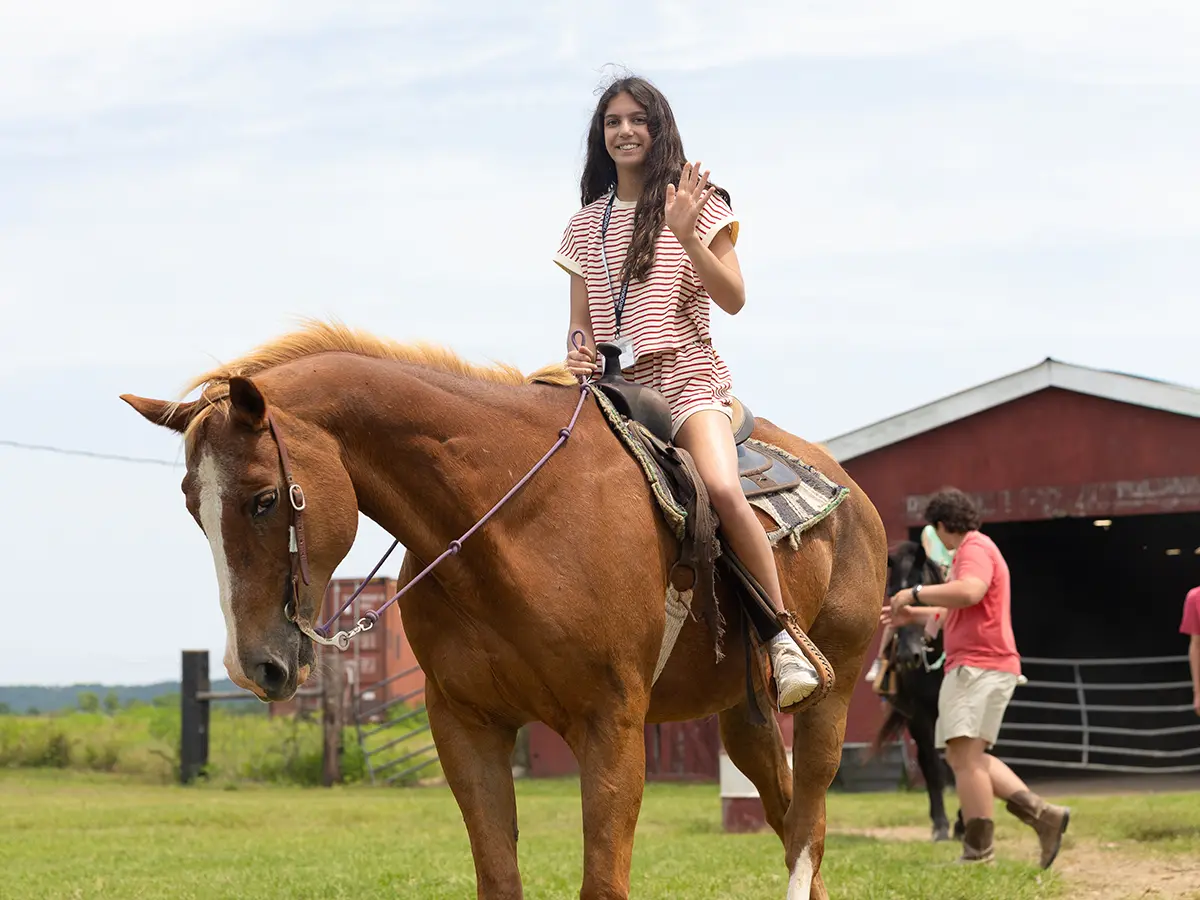 A camper riding horseback at Brookhill Ranch