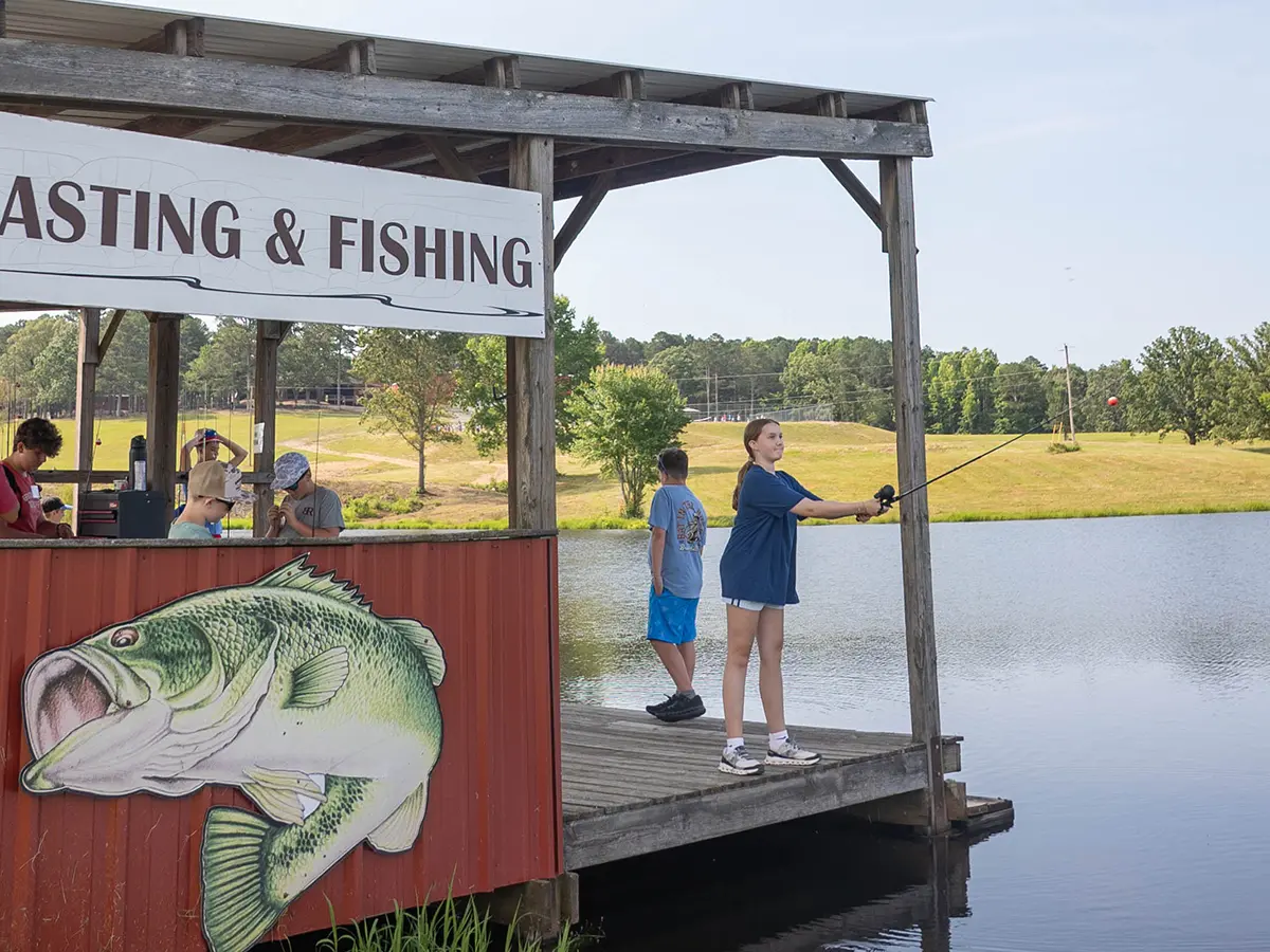A camper casting a fishing line at the Brookhill Ranch lake