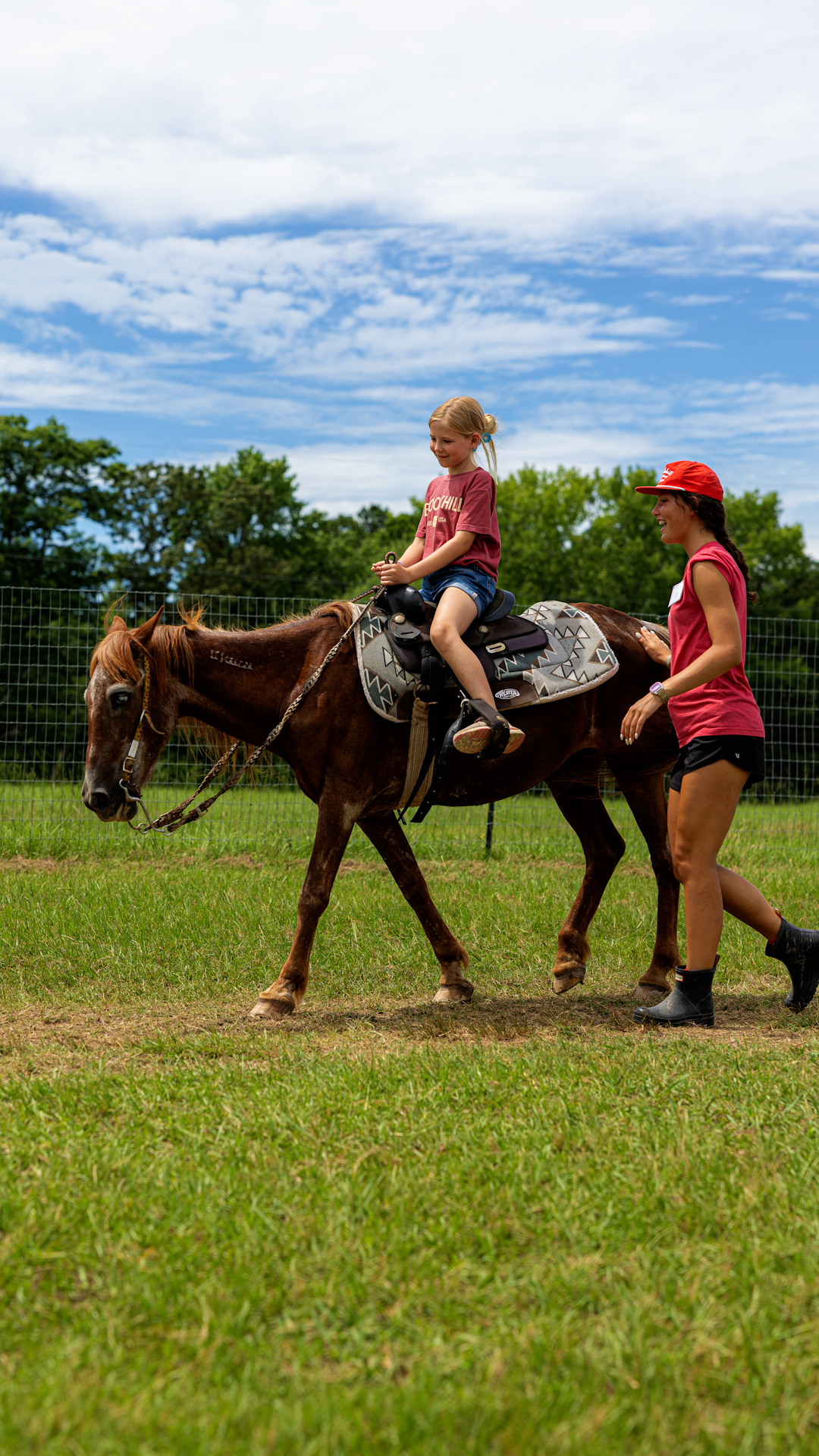 A Brookhill Ranch camper riding horseback with a counselor