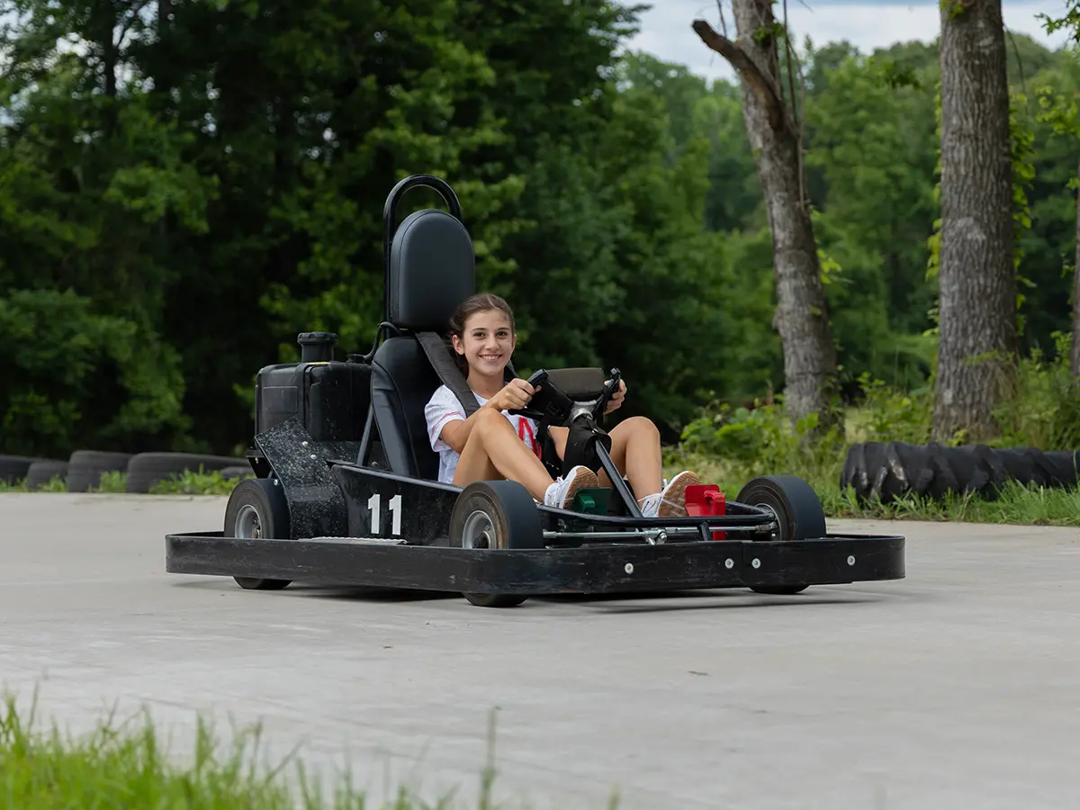 A camper driving a go kart at Brookhill Ranch